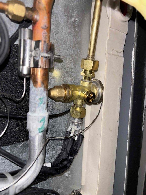 Responded to install callback for system not cooling adequately with weak airflow. System installed late June, initial callback occurred end of June for same issue. Upon arrival, indoor temperature at 75°F with thermostat set to 70°F. Attic-located system assessed and diagnosed using manifold gauges, revealing abnormal refrigerant pressures and temperatures. Low side pressure reading 124.8 PSI with suction line temperature 62.6°F and superheat 14.5°F. High side pressure reading 280.7 PSI with liquid line temperature 91.9°F and subcooling 16.0°F. Identified failed TXV (thermostatic expansion valve) as root cause of insufficient cooling capacity. TXV photographed and documented for replacement part ordering. System currently non-operational. Return visit scheduled to replace TXV, estimated repair time 120 minutes. Customer informed of findings and repair plan.