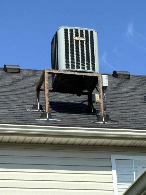 Completed comprehensive HVAC system replacement estimate for residential property featuring roof-mounted air conditioning condenser unit and indoor furnace installation. Assessed existing equipment configuration including outdoor condenser positioned on elevated wooden platform with weathered support structure on asphalt shingle roof, and indoor closet-mounted gas furnace with metallic ductwork and plenum connection. Evaluated complete system replacement requirements, documented equipment specifications, measured installation parameters, and provided homeowner with detailed replacement options for both outdoor condensing unit and indoor air handler/furnace system to ensure proper sizing and efficiency standards are met for whole-home comfort solution.