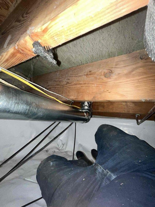 Completed dryer vent replacement in residential attic space. Installed new metallic ductwork between floor joists, properly secured with metal clamps and hangers to wooden beams, and ensured proper routing through confined crawl space. All components were measured, fitted, and fastened according to code requirements for optimal airflow and safety.