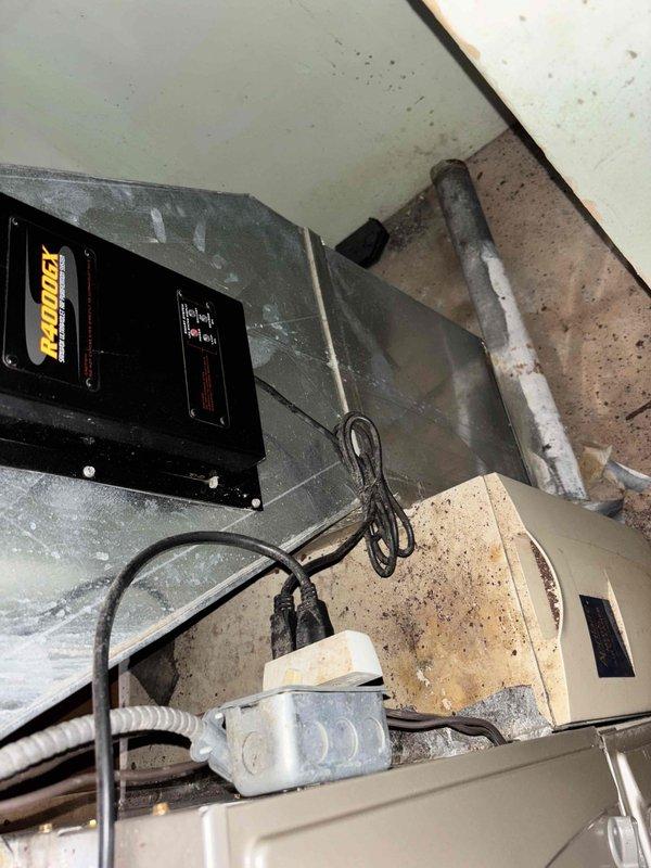 Responded to service call for non-functioning air conditioning system with indoor temperature reading 79°F while thermostat set to 67°F. Customer reported outdoor unit humming but compressor not starting, while indoor blower fan operating normally. Upon arrival, performed diagnostic evaluation of 5-6 year old HVAC system. Inspected outdoor condensing unit and confirmed compressor failure to engage despite proper fan operation. Examined indoor air handler and ductwork installation, noting normal dust accumulation consistent with system age. Documented equipment condition with photographs showing furnace assembly, ductwork configuration, refrigerant lines, and electrical connections. Provided estimate for necessary repairs to restore cooling functionality.