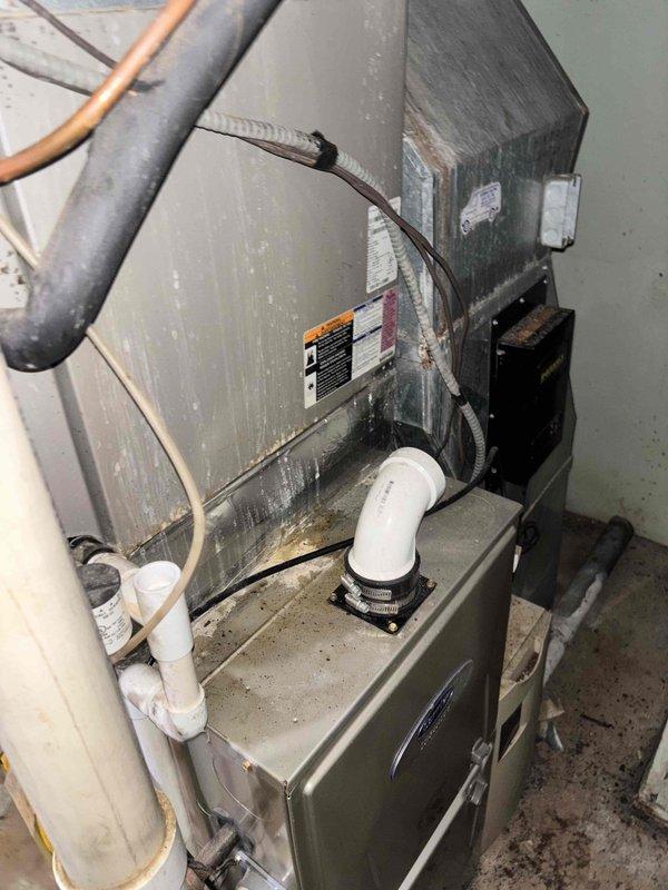 Responded to service call for non-functioning air conditioning system with indoor temperature reading 79°F while thermostat set to 67°F. Customer reported outdoor unit humming but compressor not starting, while indoor blower fan operating normally. Upon arrival, performed diagnostic evaluation of 5-6 year old HVAC system. Inspected outdoor condensing unit and confirmed compressor failure to engage despite proper fan operation. Examined indoor air handler and ductwork installation, noting normal dust accumulation consistent with system age. Documented equipment condition with photographs showing furnace assembly, ductwork configuration, refrigerant lines, and electrical connections. Provided estimate for necessary repairs to restore cooling functionality.