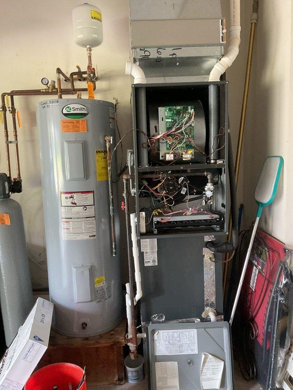 # HVAC Maintenance Service Completed

Performed comprehensive planned maintenance service on residential split-system air conditioning unit. Accessed outdoor condensing unit and inspected electrical connections, capacitor, and control components. All wiring connections were secure with proper color coding observed on capacitor terminals and control board. Verified capacitor condition and electrical components for signs of wear or deterioration.

Inspected indoor furnace unit in mechanical room, accessing internal components through front service panel. Examined circuit boards, wiring harnesses, and burner assembly for proper operation and physical condition. Verified PVC venting system connections and routing. Documented equipment condition through photographic records showing both indoor and outdoor unit components.

System operational check confirmed proper function of all major components. No deficiencies or immediate repair needs identified during inspection. Unit returned to norma