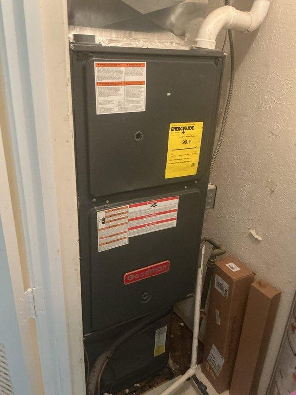 Responded to no cooling complaint on 2-year-old Goodman system. Upon arrival, verified system operation with adequate airflow through vents and no ice buildup on evaporator coil. Thermostat set at 68°F with indoor temperature reading 68°F at time of inspection, though homeowner reported intermittent temperature fluctuations to 72-75°F during warmer outdoor conditions over previous days. Inspected air filter, which showed moderate dust accumulation despite being changed approximately three weeks prior. Performed system diagnostics and confirmed unit cycling properly with no immediate mechanical faults detected. Documented installation with furnace located in utility closet with proper venting and condensate drainage via PVC piping.