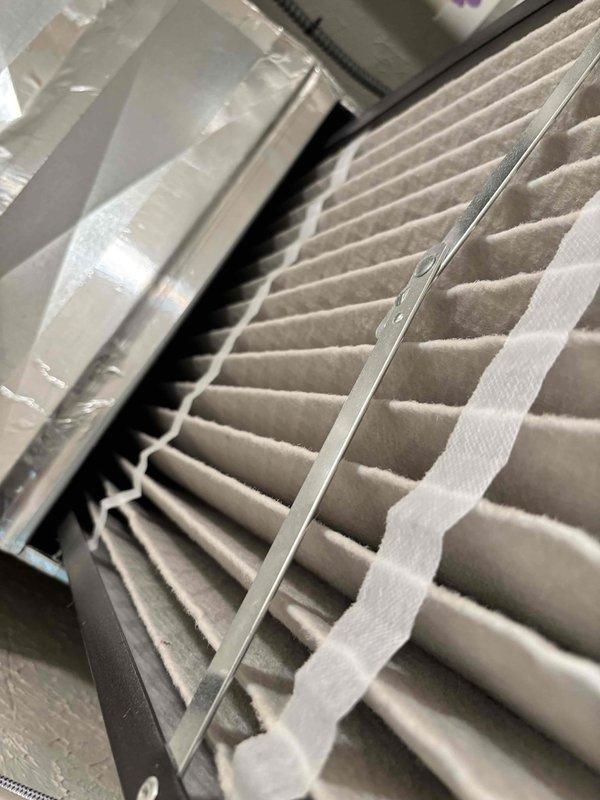 Responded to no cooling complaint on 2-year-old Goodman system. Upon arrival, verified system operation with adequate airflow through vents and no ice buildup on evaporator coil. Thermostat set at 68°F with indoor temperature reading 68°F at time of inspection, though homeowner reported intermittent temperature fluctuations to 72-75°F during warmer outdoor conditions over previous days. Inspected air filter, which showed moderate dust accumulation despite being changed approximately three weeks prior. Performed system diagnostics and confirmed unit cycling properly with no immediate mechanical faults detected. Documented installation with furnace located in utility closet with proper venting and condensate drainage via PVC piping.