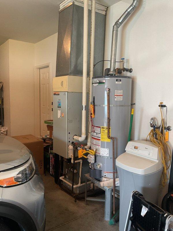 # HVAC Maintenance - Planned Single Maintenance

Completed comprehensive Gold Level planned maintenance on a 24-year-old HVAC system with Aprilaire 2400 humidifier during initial service visit. Performed thorough inspection of indoor air handler unit located in utility room alongside water heating equipment, verified proper operation of all mechanical and electrical components, and assessed outdoor condensing unit with visible aging and weathering on cabinet housing. Inspected dual capacitors and electrical connections within outdoor unit, noting disorganized wiring and surface oxidation consistent with system age, while confirming all safety controls and operational parameters met manufacturer specifications.