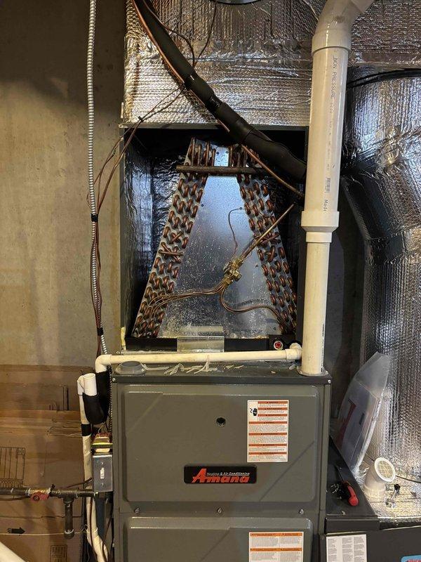 Completed comprehensive AC tune-up on 4-year-old Amana system with no reported issues. Performed full system diagnostics including electrical measurements with clamp meter, verified proper refrigerant line condition and connections at evaporator coil assembly, inspected condensate drain line operation, and confirmed all components operating within manufacturer specifications. System found in excellent working condition with no deficiencies noted.