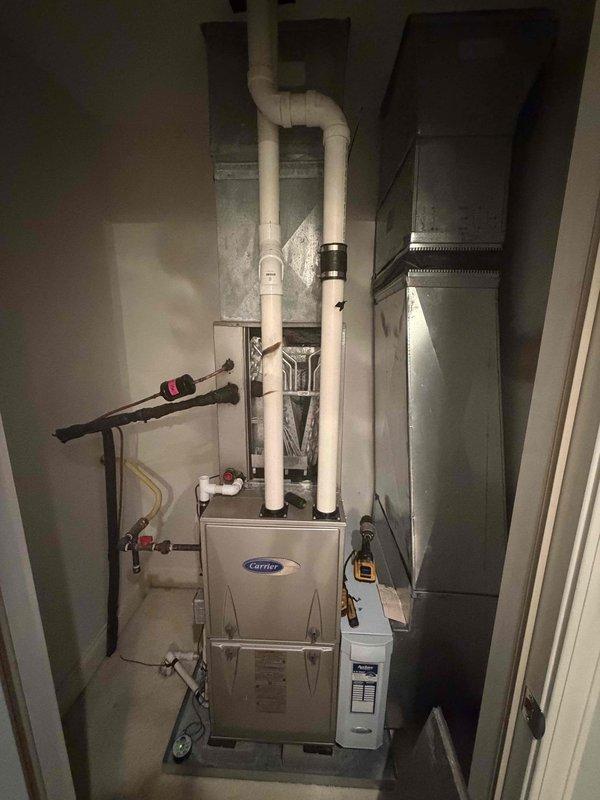 Responded to no cooling complaint on Carrier system less than 10 years old. Diagnosed failed evaporator coil in air handler unit located in utility closet. Documented coil dimensions and model information, captured photographs of failed component and system configuration for warranty claim processing. System currently non-operational; evaporator coil replacement required under warranty coverage with estimated half-day installation time upon part arrival.