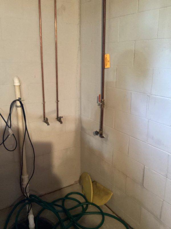 Conducted on-site estimate for replacement of existing 80-gallon electric water heater in basement. Current Lochinvar unit actively leaking and causing basement flooding, requiring urgent replacement. Assessed existing 240-volt electrical service compatibility and plumbing configuration including copper supply lines and drainage setup. Evaluated installation requirements for new 80-gallon electric tank water heater manufactured in America, including necessary shut-off valve replacement. Documented existing plumbing infrastructure, ceiling clearances, and access pathways for equipment removal and installation. Photographed current water heater location, surrounding piping system, and electrical connections to provide comprehensive assessment for replacement options.