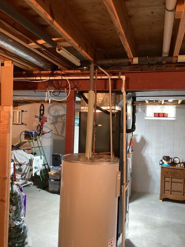 Conducted on-site estimate for replacement of existing 80-gallon electric water heater in basement. Current Lochinvar unit actively leaking and causing basement flooding, requiring urgent replacement. Assessed existing 240-volt electrical service compatibility and plumbing configuration including copper supply lines and drainage setup. Evaluated installation requirements for new 80-gallon electric tank water heater manufactured in America, including necessary shut-off valve replacement. Documented existing plumbing infrastructure, ceiling clearances, and access pathways for equipment removal and installation. Photographed current water heater location, surrounding piping system, and electrical connections to provide comprehensive assessment for replacement options.