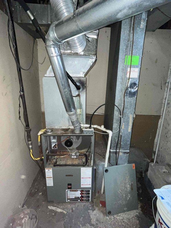 Completed full HVAC system replacement estimate for 15+ year old residential cooling system that had failed. Assessed existing gas furnace installation in basement with metallic ductwork configuration and outdoor cylindrical air conditioning condenser unit showing significant age-related wear and weathering. Provided comprehensive replacement-only options for complete system upgrade to restore cooling functionality to the property.