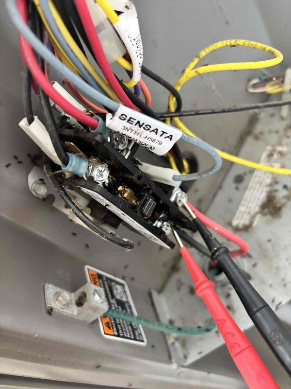 # HVAC Service Completed

Responded to no-cool call on 3-year-old air conditioning system with outdoor fan motor failure. Customer reported air movement from vents but outdoor unit fan not operating, with issue beginning the previous evening. No ice buildup, error codes, unusual noises, or odors were present at time of service call.

Upon arrival, performed visual inspection of outdoor condensing unit and confirmed fan motor was not running while indoor blower continued to operate. Removed electrical panel cover to access contactor and control wiring. Used digital multimeter to test voltage at multiple points in the electrical circuit, including contactor coil and fan motor connections.

Testing revealed Sensata relay/contactor experiencing electrical fault preventing proper fan motor operation. Verified incoming power supply was within normal parameters and checked all wire terminations for secure connections and proper torque. Inspected wiring harness including red, black, yellow, gr