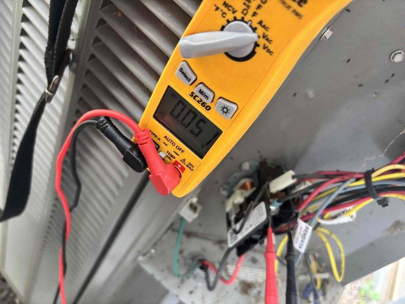 # HVAC Service Completed

Responded to no-cool call on 3-year-old air conditioning system with outdoor fan motor failure. Customer reported air movement from vents but outdoor unit fan not operating, with issue beginning the previous evening. No ice buildup, error codes, unusual noises, or odors were present at time of service call.

Upon arrival, performed visual inspection of outdoor condensing unit and confirmed fan motor was not running while indoor blower continued to operate. Removed electrical panel cover to access contactor and control wiring. Used digital multimeter to test voltage at multiple points in the electrical circuit, including contactor coil and fan motor connections.

Testing revealed Sensata relay/contactor experiencing electrical fault preventing proper fan motor operation. Verified incoming power supply was within normal parameters and checked all wire terminations for secure connections and proper torque. Inspected wiring harness including red, black, yellow, gr