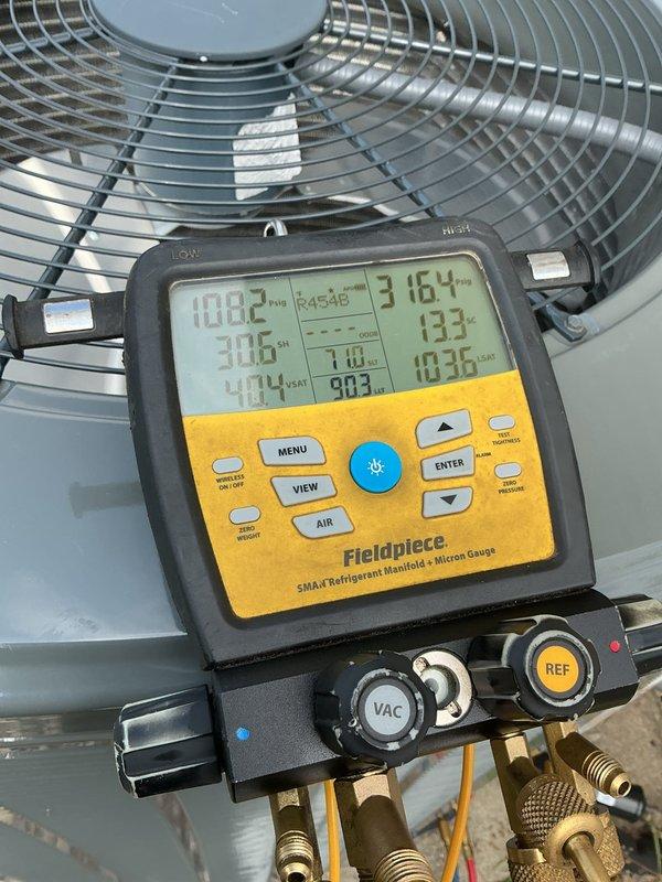 Responded to no cooling call on 10+ year old system with indoor temperature at 79°F despite thermostat set to 70°F. Upon arrival, performed comprehensive diagnostic evaluation of the air conditioning system using refrigerant manifold and micron gauge. Connected diagnostic equipment to outdoor condenser unit and recorded system pressures and temperatures to assess refrigerant charge levels and compressor performance. Measurements indicated operating pressures of 124.8 PSI and 133 PSI with ambient temperature readings of 108.2°F at condenser and 98.3°F discharge line temperature. Verified electrical components, checked for tripped breakers, and confirmed condenser fan motor operation. Conducted thorough system analysis to identify root cause of cooling failure and provided recommendations for necessary repairs to restore proper cooling function.
