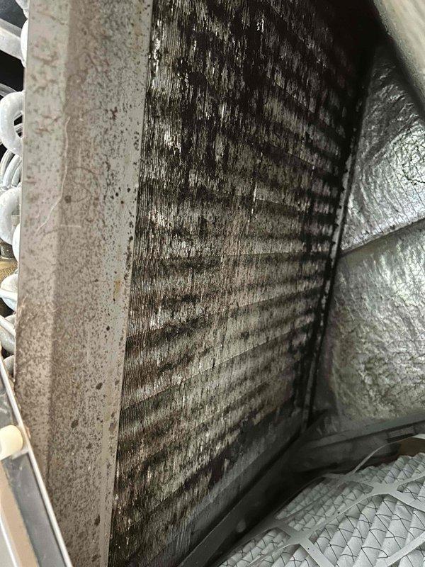 Responded to no cooling complaint with thermostat set to 70°F but interior temperature at 78°F. Upon inspection, found evaporator coil heavily soiled with extensive dirt and dust accumulation restricting airflow, which caused previous freezing condition that required defrosting. Documented severely contaminated coil fins with significant buildup between metal slats, confirming restricted airflow as primary cause of system failure and inadequate cooling performance.
