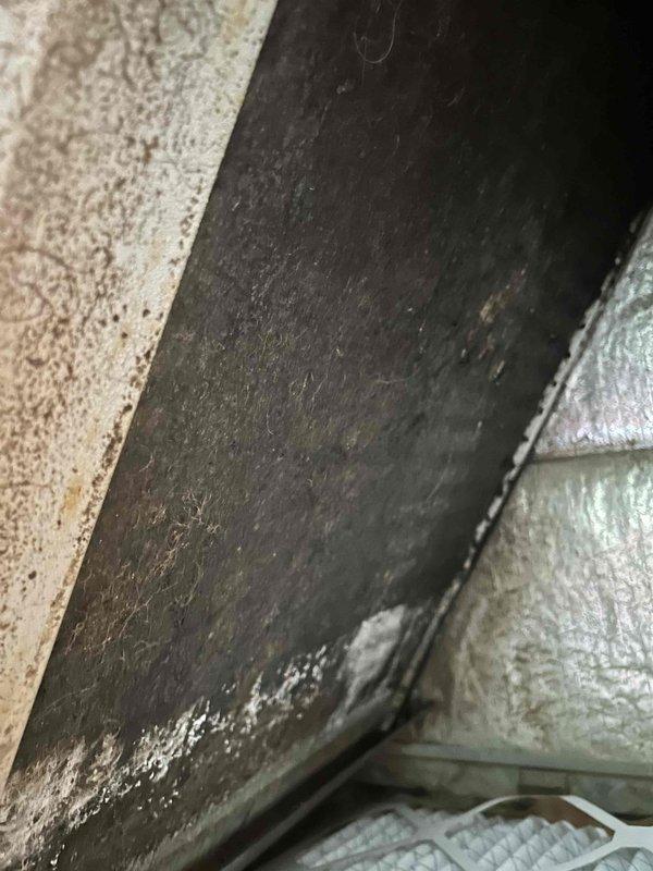 Responded to no cooling complaint with thermostat set to 70°F but interior temperature at 78°F. Upon inspection, found evaporator coil heavily soiled with extensive dirt and dust accumulation restricting airflow, which caused previous freezing condition that required defrosting. Documented severely contaminated coil fins with significant buildup between metal slats, confirming restricted airflow as primary cause of system failure and inadequate cooling performance.