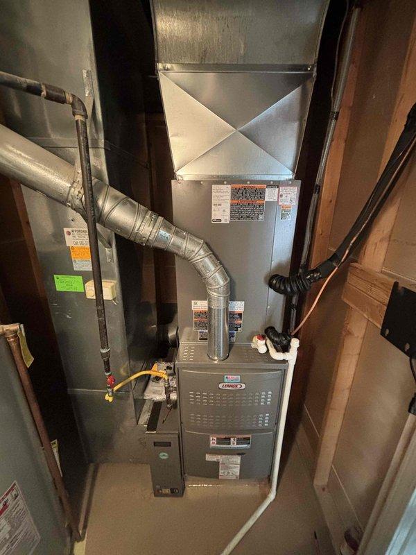 Completed full HVAC system installation consisting of a 5-ton Lennox 15.2 SEER air conditioning unit paired with an 80% AFUE upflow gas furnace in basement utility space. Installed air handler with evaporator coil, connected flexible metallic ductwork, verified proper unit leveling, and ensured all components meet manufacturer specifications and code compliance requirements.