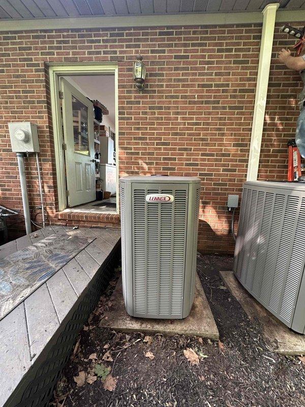 # HVAC System Installation

Completed full residential HVAC system installation featuring a 3-ton Lennox 18 SEER2 unit with 99% AFUE upflow fully modulating furnace. Indoor furnace unit installed in interior utility closet with proper clearances maintained for water heater and adequate ventilation access. Outdoor Lennox condenser positioned on concrete pad beneath covered porch area with appropriate spacing from building structure and secondary equipment. All refrigerant lines connected and tested, electrical connections completed to code, condensate drainage established, and system commissioned with full operational testing of modulating capabilities across heating and cooling modes.