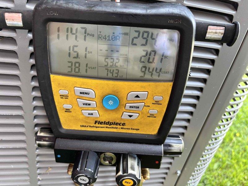Responded to no cooling complaint on unit less than 10 years old with history of recent thermostat replacement and repeated outages. Upon arrival, verified thermostat was blank with last reading at 75 degrees, confirmed no ice formation on refrigerant lines, and verified electrical supply at breaker panel. Performed system diagnostics using refrigerant manifold gauges, confirmed R410A refrigerant pressures with suction side reading 147 PSI and discharge side reading 294 PSI. Inspected condensate drain line and PVC fittings for proper drainage and potential blockages. System restored to normal cooling operation.