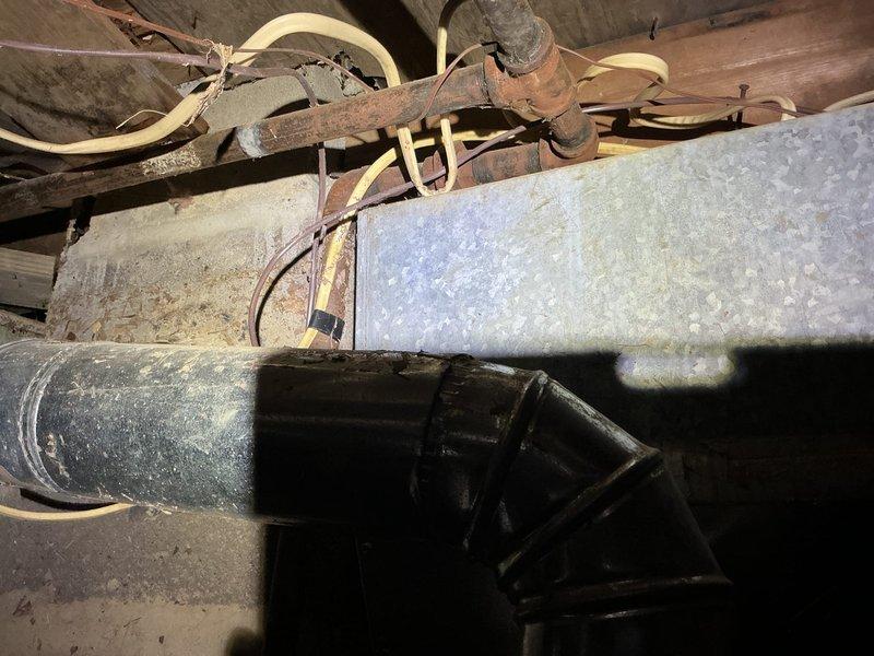 Completed on-site walkthrough and photo documentation for HVAC estimate preparation. Inspected existing mechanical systems in crawl space area, noting aged ductwork with deteriorated insulation and corroded piping requiring evaluation for replacement or repair. Interior laundry/utility room assessed for potential equipment placement and access considerations to facilitate estimate development.