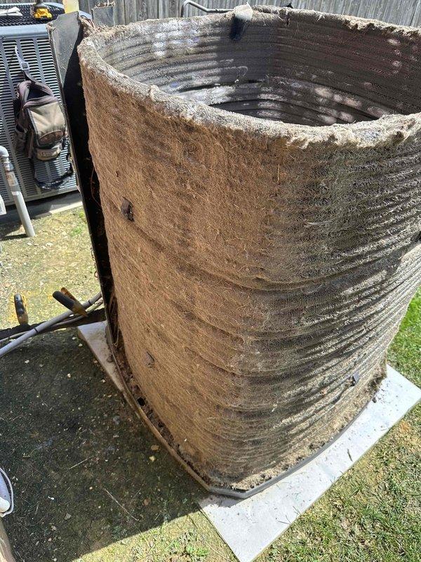 Responded to no-cool complaint on 5-year-old upstairs system unable to maintain setpoint below 79°F with high humidity. Upon arrival, inspected outdoor condensing unit and found extensive external contamination with heavy dirt and debris accumulation on condenser coil fins, significantly restricting airflow and reducing heat transfer efficiency. Unit exterior showed severe weathering and deterioration of protective casing. System has documented history of refrigerant loss indicating potential leak in refrigerant circuit. Due to extreme coil fouling and suspected refrigerant leak, recommended scheduling return visit for comprehensive leak search and system evaluation. Customer advised that service must be scheduled after 9 AM due to availability constraints. Secondary cooling system operational on first floor providing temporary relief.
