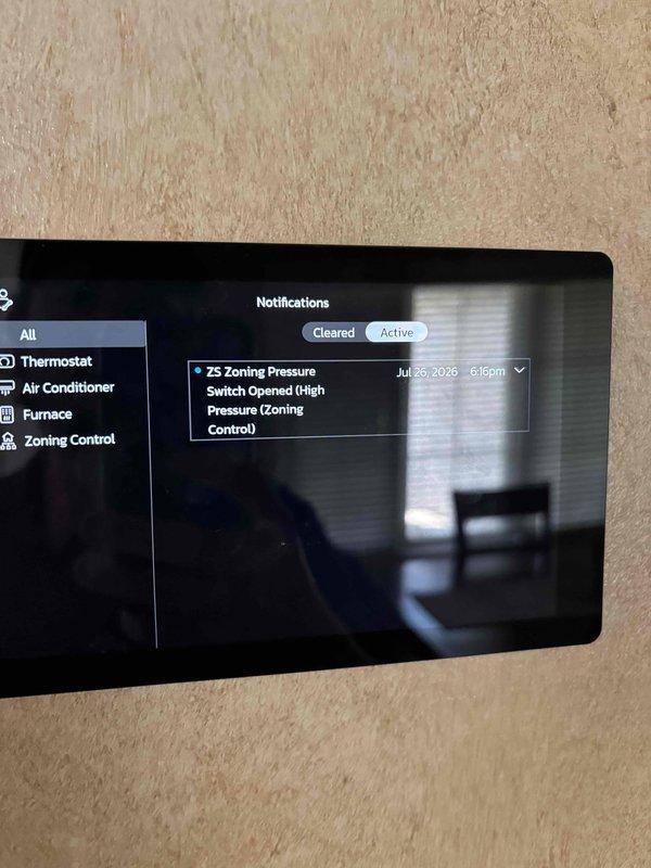 Completed annual planned maintenance on one-year-old HVAC system during second visit. Performed standard maintenance procedures, inspected outdoor condenser unit on concrete pad, and noted active zoning pressure switch notification (high pressure) on system's digital control interface requiring further evaluation.