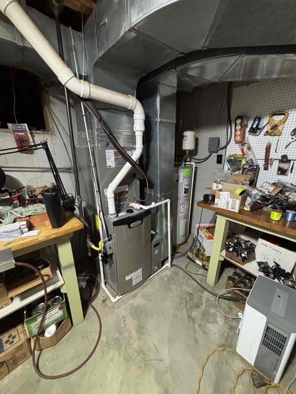 Completed full HVAC system installation featuring a Lennox furnace configured as a 19 SEER/99% AFUE dual fuel system with LP conversion kit. Installation included proper venting with white PVC intake and exhaust piping, copper refrigerant line routing, gas line connection with shut-off valve, electrical connections, and integration with existing ductwork in mechanical room.