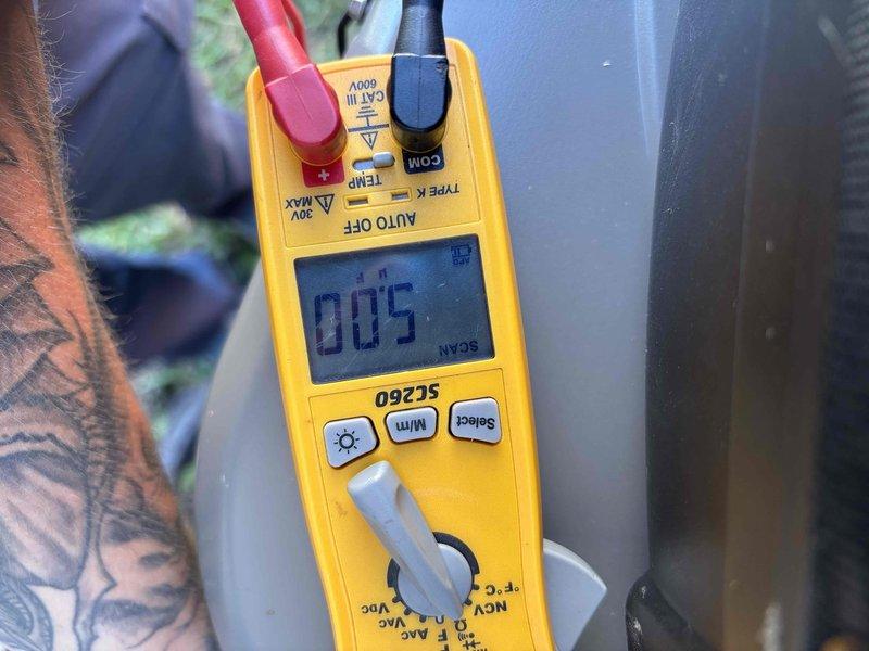 # HVAC Maintenance Service Completed

Performed comprehensive preventive maintenance on a two-year-old residential air conditioning system per customer's scheduled tune-up request. System was operating normally with no reported issues at time of service.

Conducted complete electrical diagnostics using digital multimeter to verify proper voltage and amperage across system components. All electrical readings confirmed within manufacturer specifications. Measured supply air temperature at 50.9°F, indicating adequate cooling performance and proper refrigerant charge levels.

Completed standard maintenance protocol including inspection of all major components, verification of operational parameters, and system performance assessment. All measurements and observations documented photographically for service records. System left in proper working order with all safety controls functioning as designed.