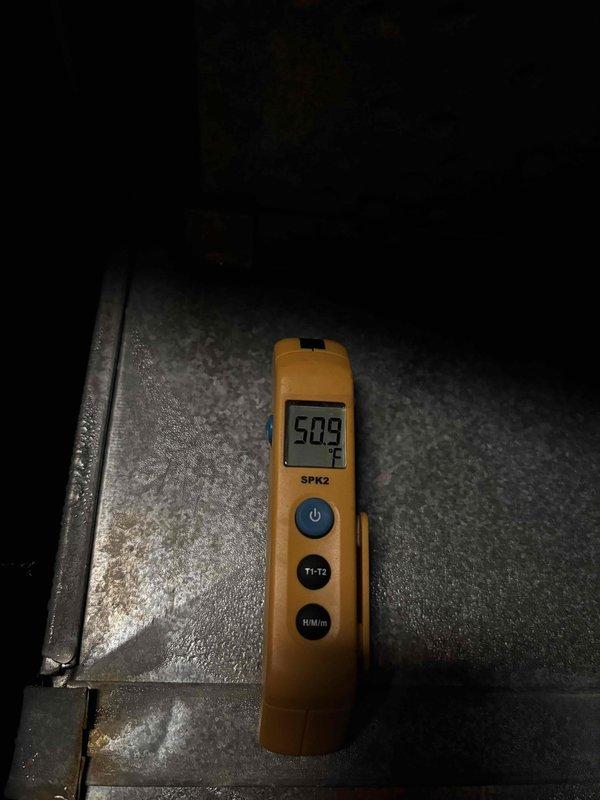 # HVAC Maintenance Service Completed

Performed comprehensive preventive maintenance on a two-year-old residential air conditioning system per customer's scheduled tune-up request. System was operating normally with no reported issues at time of service.

Conducted complete electrical diagnostics using digital multimeter to verify proper voltage and amperage across system components. All electrical readings confirmed within manufacturer specifications. Measured supply air temperature at 50.9°F, indicating adequate cooling performance and proper refrigerant charge levels.

Completed standard maintenance protocol including inspection of all major components, verification of operational parameters, and system performance assessment. All measurements and observations documented photographically for service records. System left in proper working order with all safety controls functioning as designed.