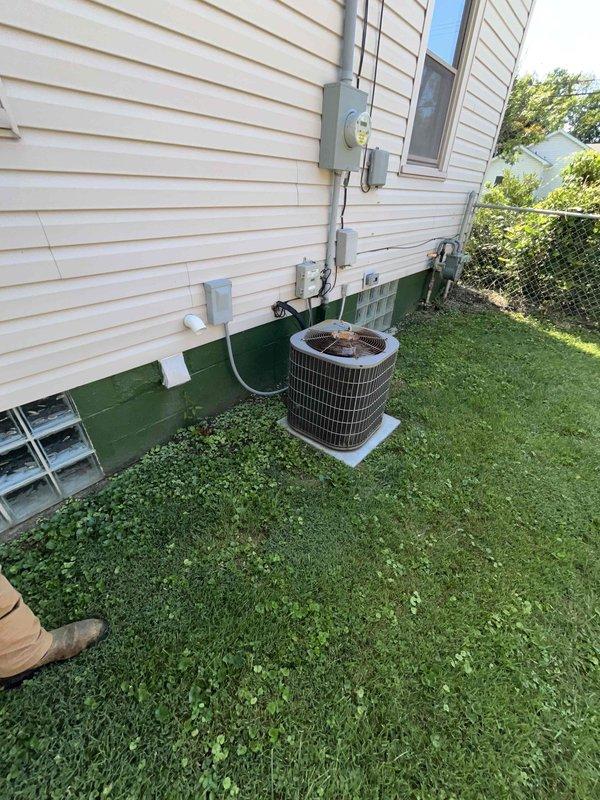 Conducted comprehensive HVAC system evaluation for complete replacement estimate on aging residential installation. Assessed exterior condensing unit showing significant weathering and rust deterioration on protective grille, documented electrical service connections and meter configuration, and evaluated existing thermostat wiring configuration on UWP12 control module with multi-stage capability. Photographed all equipment conditions and provided detailed replacement recommendations for new energy-efficient system.