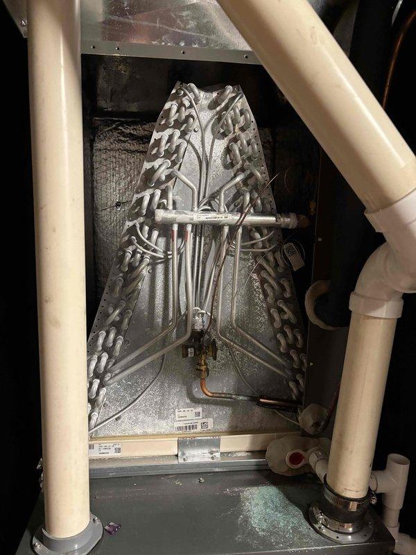 Completed planned maintenance visit on single-system residential HVAC unit with 16x25x1 filter configuration. Performed comprehensive system inspection including evaporator coil assessment, verified proper drainage function, and measured electrical parameters using digital multimeter, recording 39.94 volts at the unit. All components found operating within normal specifications, with coil showing appropriate condensation patterns indicating proper refrigerant cycle operation.