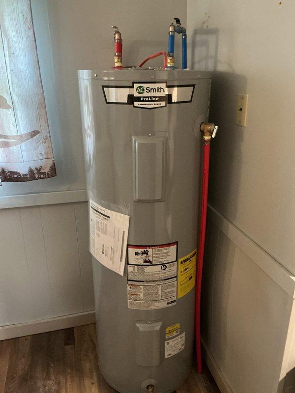 Installed a 50-gallon AO Smith ProLine electric residential water heater in utility closet. Connected hot and cold water supply lines with proper color-coded flexible connectors and brass fittings, ensuring all plumbing connections were secure and leak-free per manufacturer specifications.