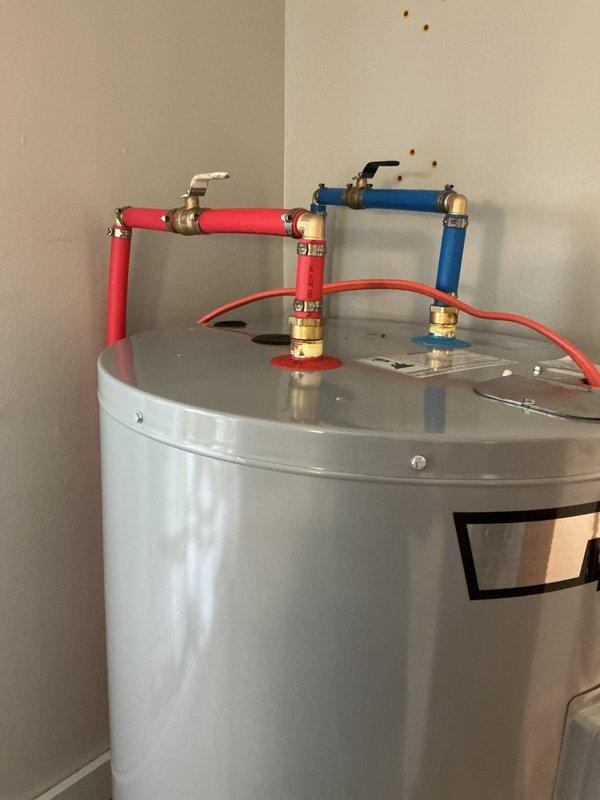 Installed a 50-gallon AO Smith ProLine electric residential water heater in utility closet. Connected hot and cold water supply lines with proper color-coded flexible connectors and brass fittings, ensuring all plumbing connections were secure and leak-free per manufacturer specifications.