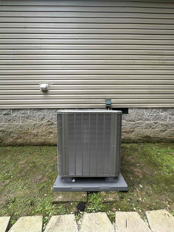 Completed full HVAC system replacement installing a 3-ton Lennox 15.5 SEER heat pump with matching air handler. Positioned outdoor condensing unit on concrete pad against building exterior with proper clearances, ran refrigerant linesets along exterior wall with secure mounting brackets, and installed electrical disconnect box per code requirements. System commissioned and tested for proper operation.