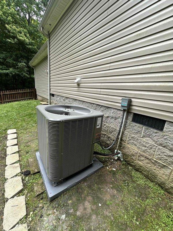 Completed full HVAC system replacement installing a 3-ton Lennox 15.5 SEER heat pump with matching air handler. Positioned outdoor condensing unit on concrete pad against building exterior with proper clearances, ran refrigerant linesets along exterior wall with secure mounting brackets, and installed electrical disconnect box per code requirements. System commissioned and tested for proper operation.