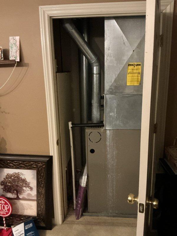 Responded to service call for excessive indoor humidity levels reaching 70 percent with visible mold growth, despite system maintaining cooling function. Performed diagnostic evaluation of 4-year-old HVAC system to identify dehumidification failure. Inspected furnace unit, ductwork connections, and condensate drainage system. Discovered compromised insulation and possible airflow restriction in wall cavity near air handler, with displaced fiberglass insulation and flexible drainage lines requiring attention. Documented equipment condition and system performance issues affecting humidity control. Provided recommendations for insulation repair, condensate line maintenance, and potential dehumidification enhancement to resolve moisture control problems and prevent further mold development.