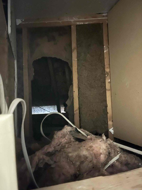 Responded to service call for excessive indoor humidity levels reaching 70 percent with visible mold growth, despite system maintaining cooling function. Performed diagnostic evaluation of 4-year-old HVAC system to identify dehumidification failure. Inspected furnace unit, ductwork connections, and condensate drainage system. Discovered compromised insulation and possible airflow restriction in wall cavity near air handler, with displaced fiberglass insulation and flexible drainage lines requiring attention. Documented equipment condition and system performance issues affecting humidity control. Provided recommendations for insulation repair, condensate line maintenance, and potential dehumidification enhancement to resolve moisture control problems and prevent further mold development.