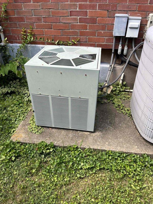Completed equipment assessment and replacement estimate for aging HVAC system including upstairs furnace (30+ years old, closet-mounted) and upstairs air conditioning unit (27 years old, exterior installation). Both systems evaluated for proactive replacement due to age rather than active failure. Documented existing outdoor condenser unit positioned on concrete pad against building exterior with electrical disconnect present. Identified mercury-containing thermostat requiring proper disposal procedures during replacement. Photographed current equipment configuration and provided comprehensive replacement options for complete system upgrade.