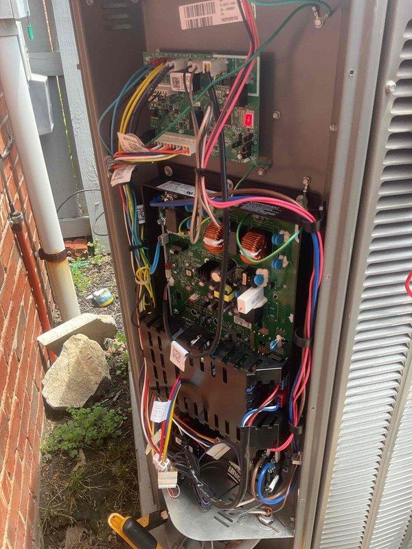 Responded to service call for condensation leak around outdoor AC unit. Upon arrival, opened access panel and inspected internal components, electrical connections, and control boards for potential causes of water leakage. System was actively cooling at time of inspection. Documented unit condition with photos showing circuit boards, wiring harnesses, and internal components. Identified need for refrigerant charge verification on return visit to complete diagnosis and resolve condensation issue.