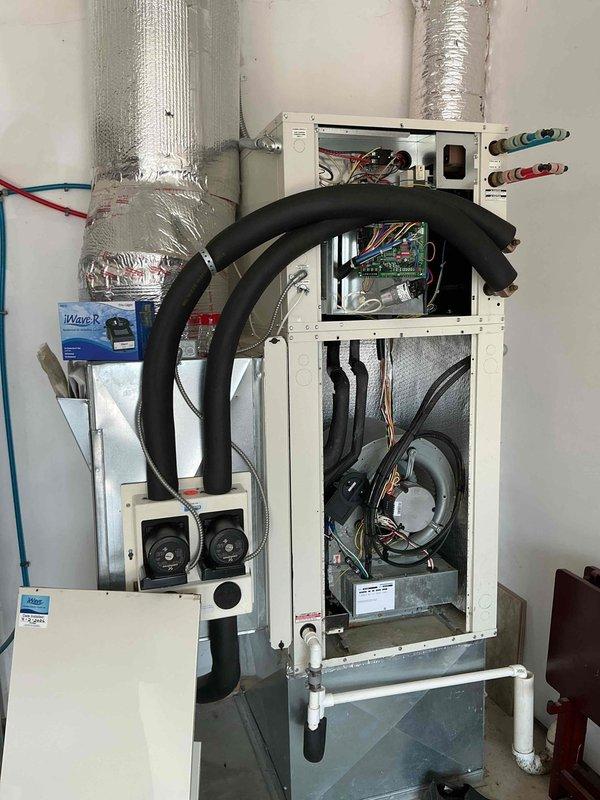 Responded to no cooling call on 9-year-old geothermal heat pump system with no airflow and complete system failure. Upon arrival, confirmed thermostat set to 72°F with indoor temperature at 80°F and unit unresponsive. Performed diagnostic evaluation of air handler and control systems, inspecting electrical connections, circuit boards, blower assembly, and refrigerant lines. Identified system fault preventing operation and restored cooling functionality. Verified proper airflow through supply vents, confirmed thermostat communication with equipment, and tested all safety controls for proper operation. System returned to normal cooling mode with adequate airflow and temperature differential.