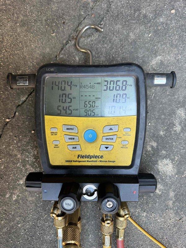 Completed installation of Lennox HVAC system at residential property. Unit was properly positioned on concrete pad with decorative landscaping blocks, refrigerant lines routed along exterior brick wall, and all connections secured. System was charged with R454B refrigerant and verified operational parameters using digital manifold gauges, confirming proper pressures and temperatures within manufacturer specifications.