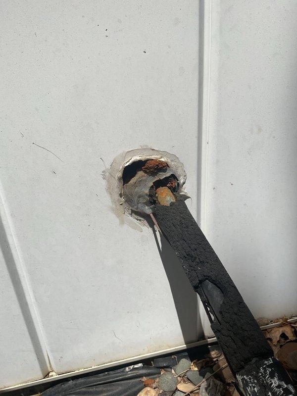 Conducted comprehensive replacement estimate for 23-year-old HVAC system experiencing water leakage issues. Evaluated existing outdoor condensing unit and indoor furnace installation, documented current equipment condition including corroded penetrations and aging refrigerant lines, and assessed structural considerations for new system installation. Provided homeowner with complete replacement options and specifications for new furnace and air conditioning system to address failing equipment.