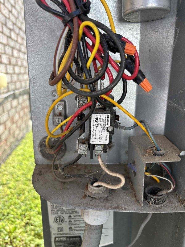 Completed scheduled preventive maintenance on residential air conditioning system. Performed comprehensive AC tune-up including inspection of electrical components, contactors, and capacitor within control panel. Verified system operation with amperage readings at 49.8 amps using digital multimeter. All electrical connections tested and found secure, though control panel showed normal weathering consistent with outdoor installation. System operating within manufacturer specifications with no issues identified or repairs required at time of service.