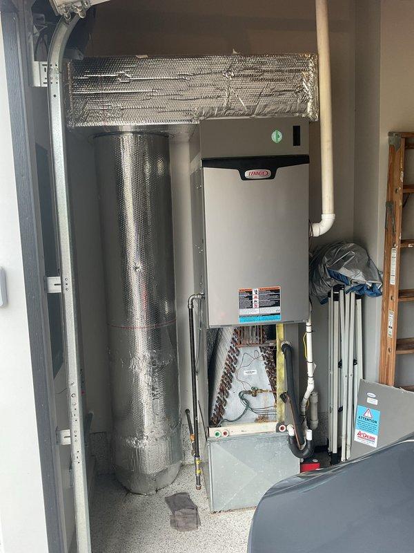 Responded to water leak complaint on 2-year-old Lennox HVAC system located in garage. Upon inspection, identified failed drain pan with active leak from back left corner causing water pooling beneath unit. Leak had been occurring for approximately one week, initially appearing as minor condensation before progressing to significant water accumulation. Confirmed no structural damage to surrounding area. Replaced defective drain pan and verified proper drainage operation. Additionally installed iWave air purification system and UVC bulb assembly per homeowner request to enhance indoor air quality. Provided estimate for iWave and UVC installation on secondary downstairs system. All work completed successfully with system restored to full operational status.