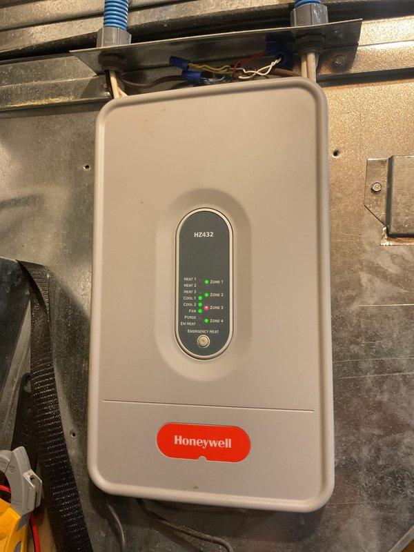Completed scheduled AC tune-up and preventative maintenance on residential air conditioning system. Performed comprehensive inspection of multi-zone HVAC equipment including Honeywell zone control panel (HZ432) with all four zones operational and indicating proper function. Inspected ductwork installation in attic space, verified proper connections and securing of flexible and sheet metal ducts, and confirmed adequate insulation coverage throughout accessible areas.
