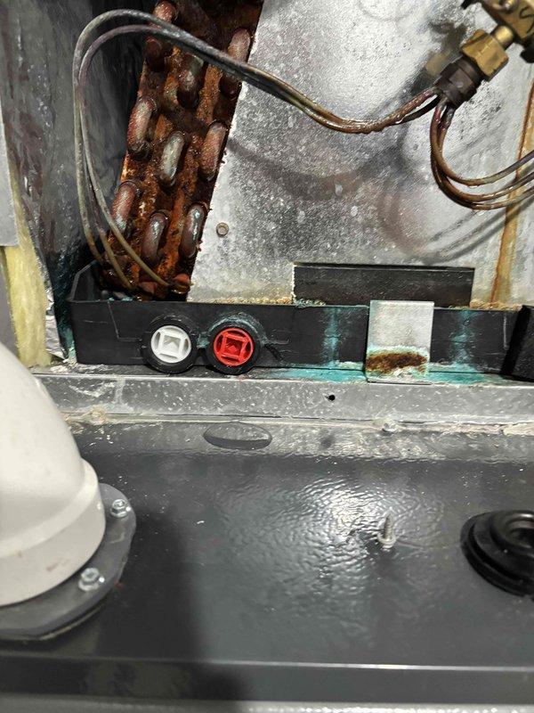 Completed second annual Platinum Level planned maintenance on dual HVAC system with 4-year-old units utilizing 20x25x5 and 16x25x5 filters. Performed comprehensive inspection of both systems, including evaporator coil assemblies, electrical connections, and refrigerant lines. Documented significant copper coil oxidation and corrosion throughout both evaporator sections, with heavy discoloration concentrated on lower coil portions indicating prolonged moisture exposure. Inspected all electrical wiring, thermostat connections, and control components for proper operation. Verified integrity of refrigerant lines, connection ports, and service valves. Noted extensive rust formation on metal coil elements and surrounding components, suggesting ongoing condensation issues requiring monitoring. Checked condensate drainage system and mounting brackets for structural integrity. All functional components including motors, capacitors, and connection fittings remain operational despite visible age-
