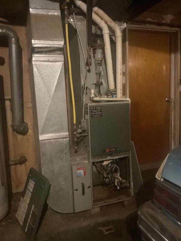 Completed comprehensive HVAC replacement estimate for residential property with non-functional existing system. Assessed current gray furnace unit with air handler, documented all mechanical components including PVC venting, gas line configuration, and electrical connections in basement utility area. Provided homeowner with complete replacement options and system specifications for new equipment installation.