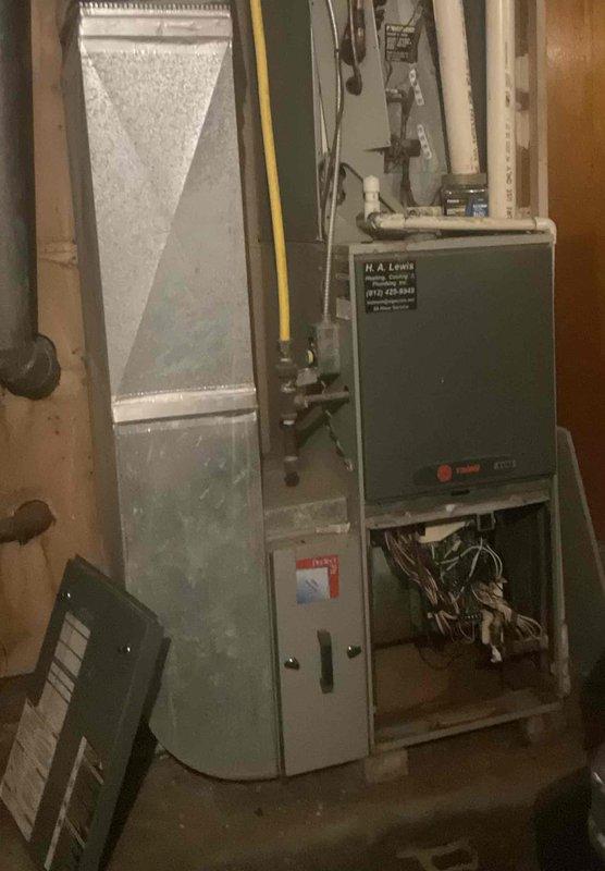 Completed comprehensive HVAC replacement estimate for residential property with non-functional existing system. Assessed current gray furnace unit with air handler, documented all mechanical components including PVC venting, gas line configuration, and electrical connections in basement utility area. Provided homeowner with complete replacement options and system specifications for new equipment installation.