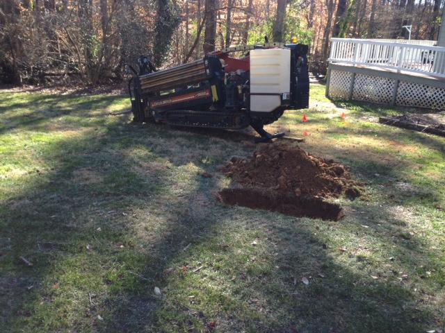 Bored 2" forced sewer under creek and tied into county sewer tap