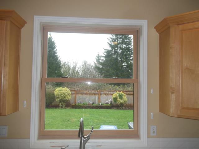 Oregon City, OR - Replace original white vinyl. Picture of a double hung windows with oak interior. Oregon City, OR - Replace original white vinyl. Picture of a double hung windows with oak interior.