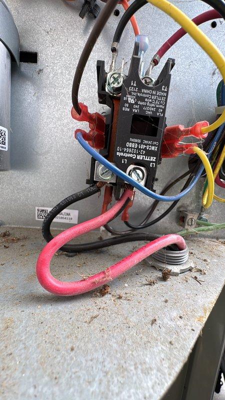 Performed diagnostic on AC system with reported compressor issue. Inspected electrical control system components including contactor/relay and associated wiring connections. Examined system interior including copper refrigerant lines, insulation, and drainage components to determine source of cooling failure.